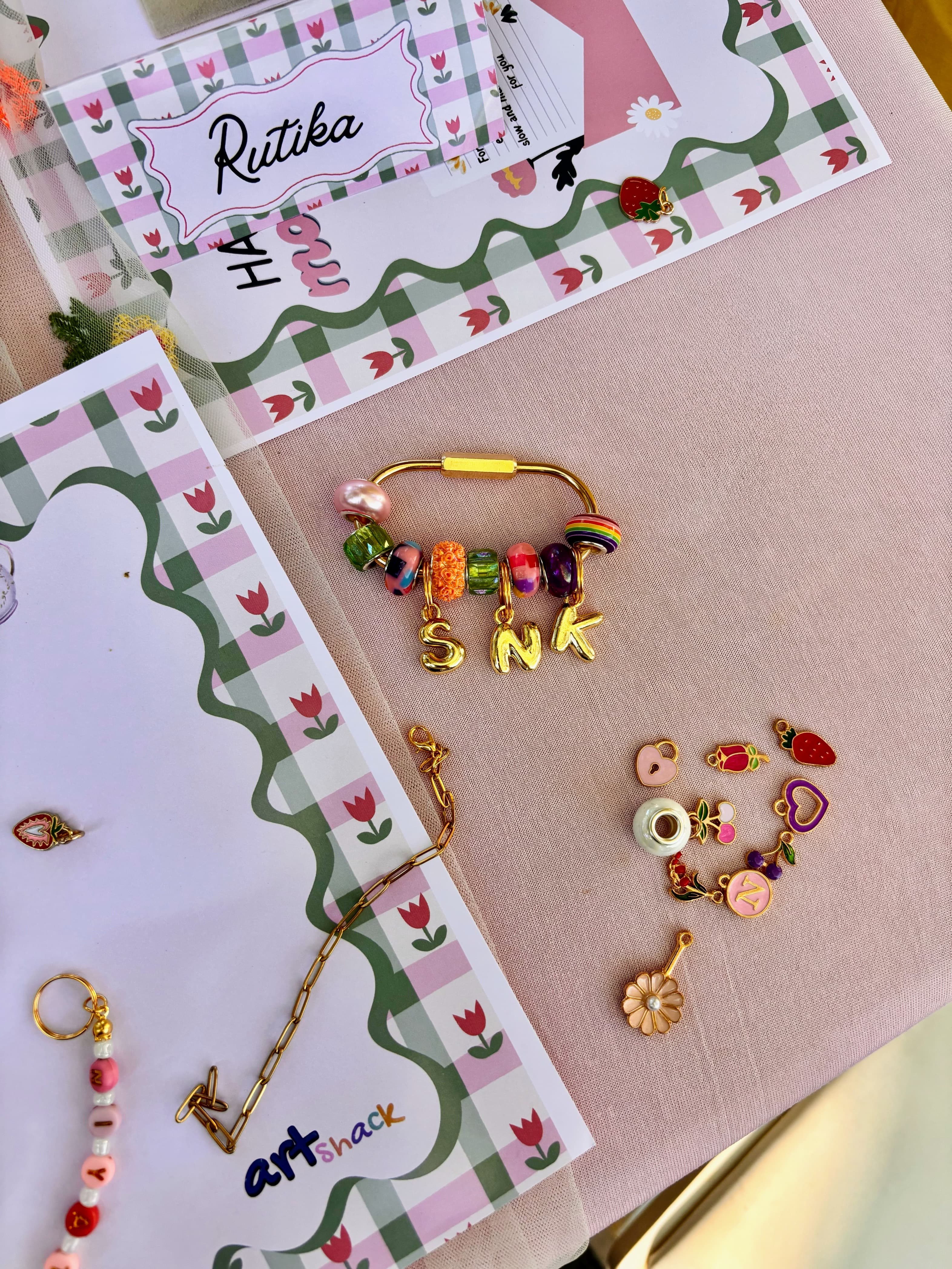 Finished bracelet with letter charms and colorful glass beads — made in one afternoon